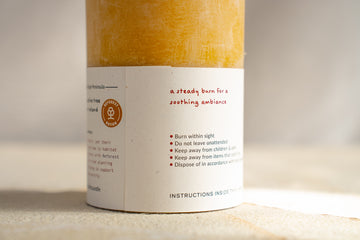 Close up of West Coast Crafts round beeswax candle label 